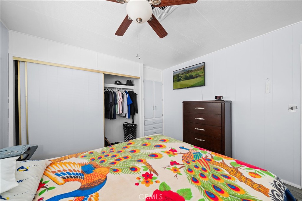 9391 California Avenue, Unit 56 Riverside, CA 92503 - Photo 28 of 45 a bedroom with a bed and wooden floor