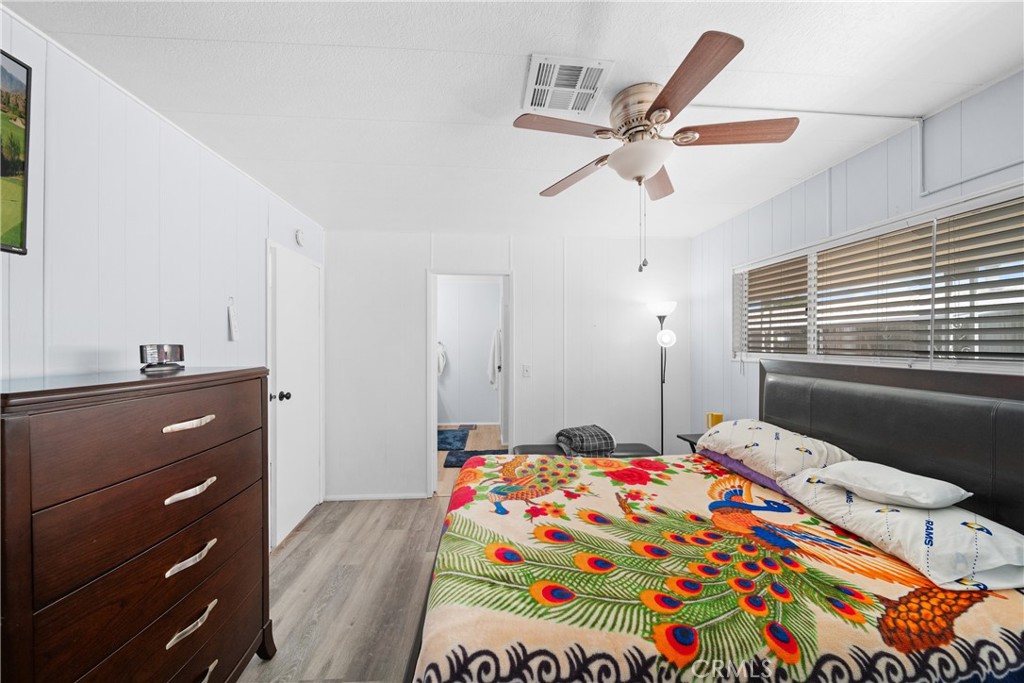 9391 California Avenue, Unit 56 Riverside, CA 92503 - Photo 29 of 45 a bedroom with a bed and a dresser in it