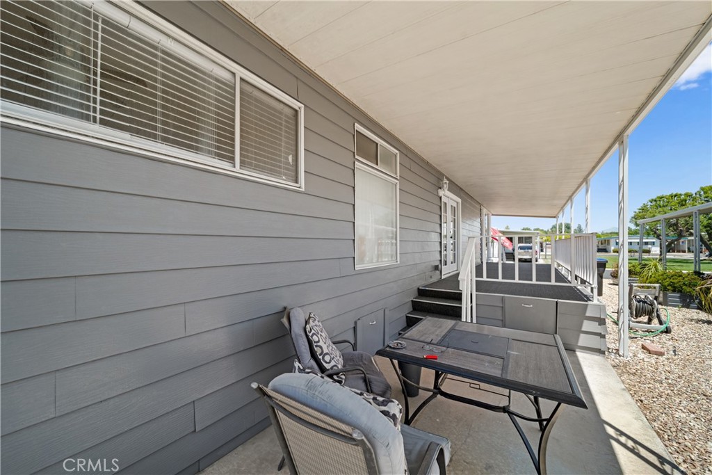 9391 California Avenue, Unit 56 Riverside, CA 92503 - Photo 7 of 45 a view of a patio with couches chairs potted plants and wooden floor