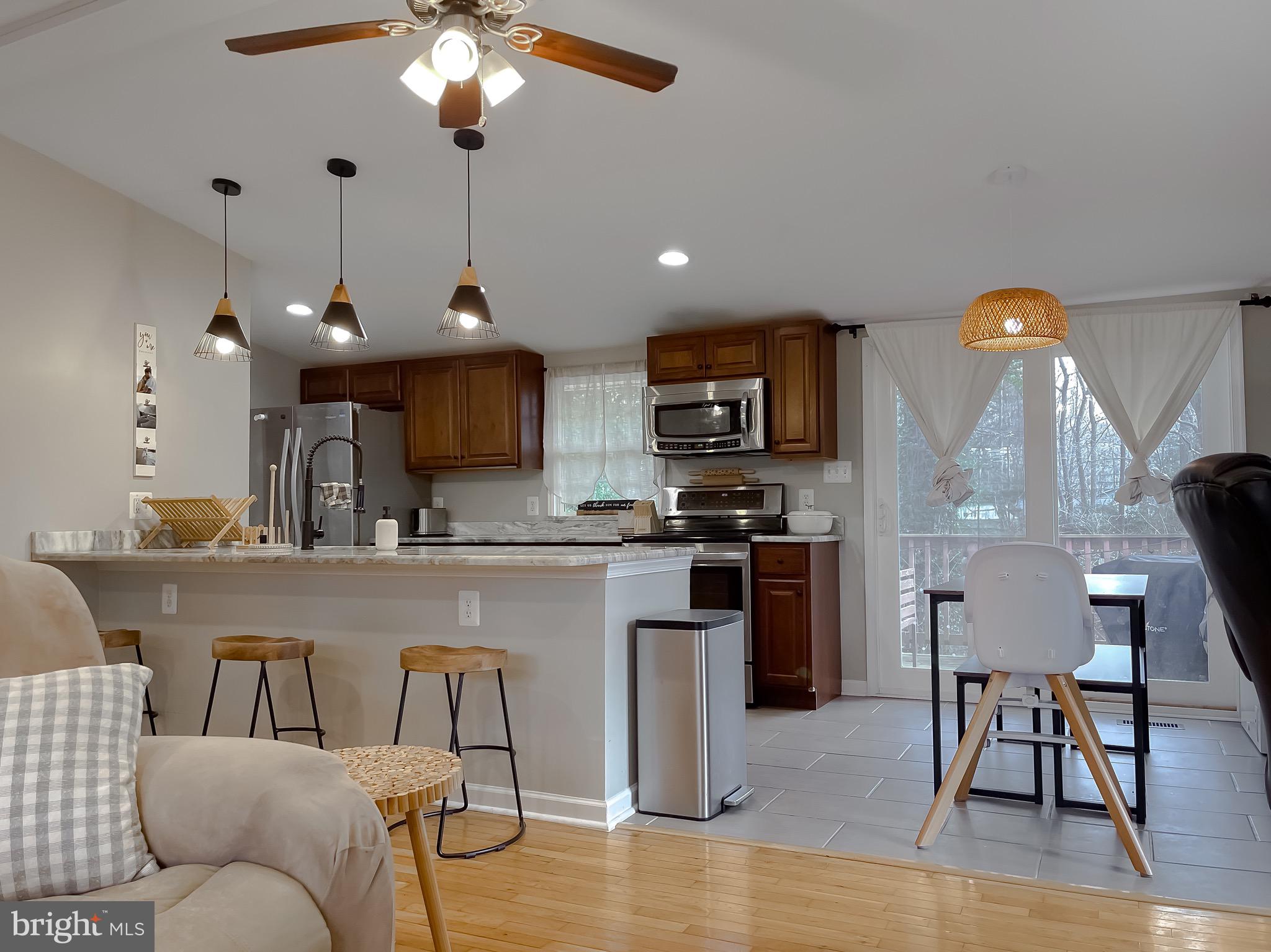 12028 Double Tree Lane Lusby, MD 20657 - Photo 2 of 40 a view of kitchen with cabinets and wooden floor