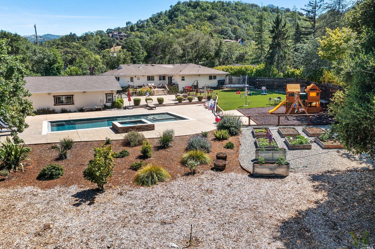 an aerial view of a house with garden space and houses