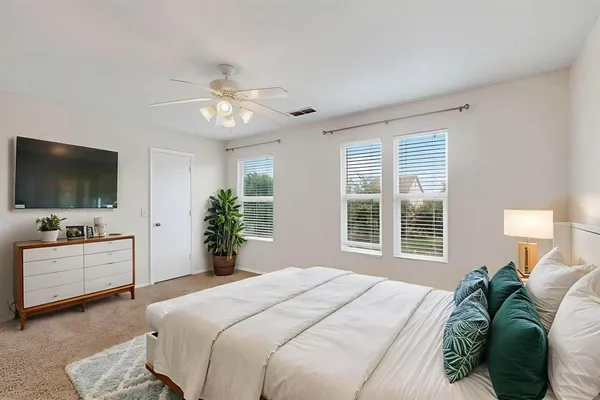 a bedroom with a bed and a flat screen tv