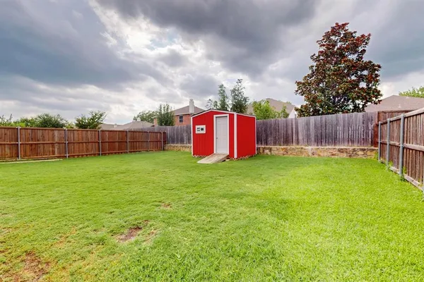 a view of yard with swimming pool and wooden fence