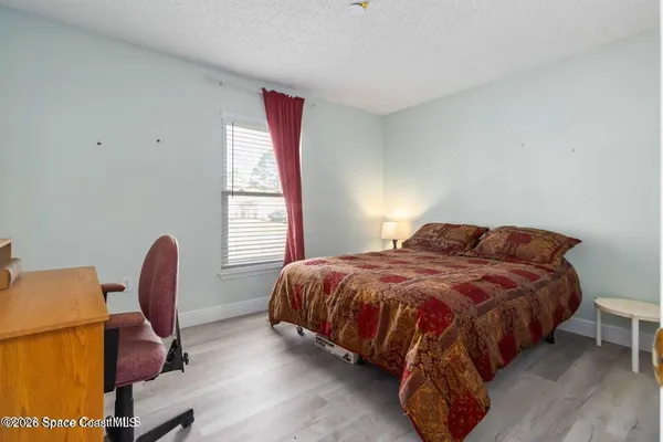 a bedroom with a bed and a chair