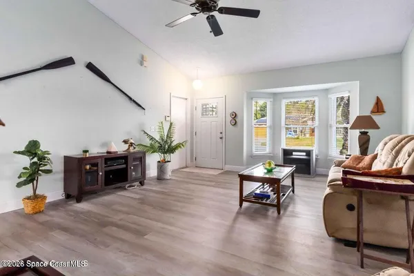 a living room with furniture and wooden floor