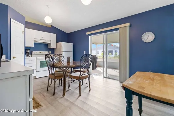 a view of a dining room with furniture and wooden floor