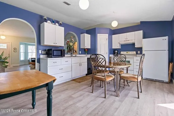 a dining room with furniture and wooden floor