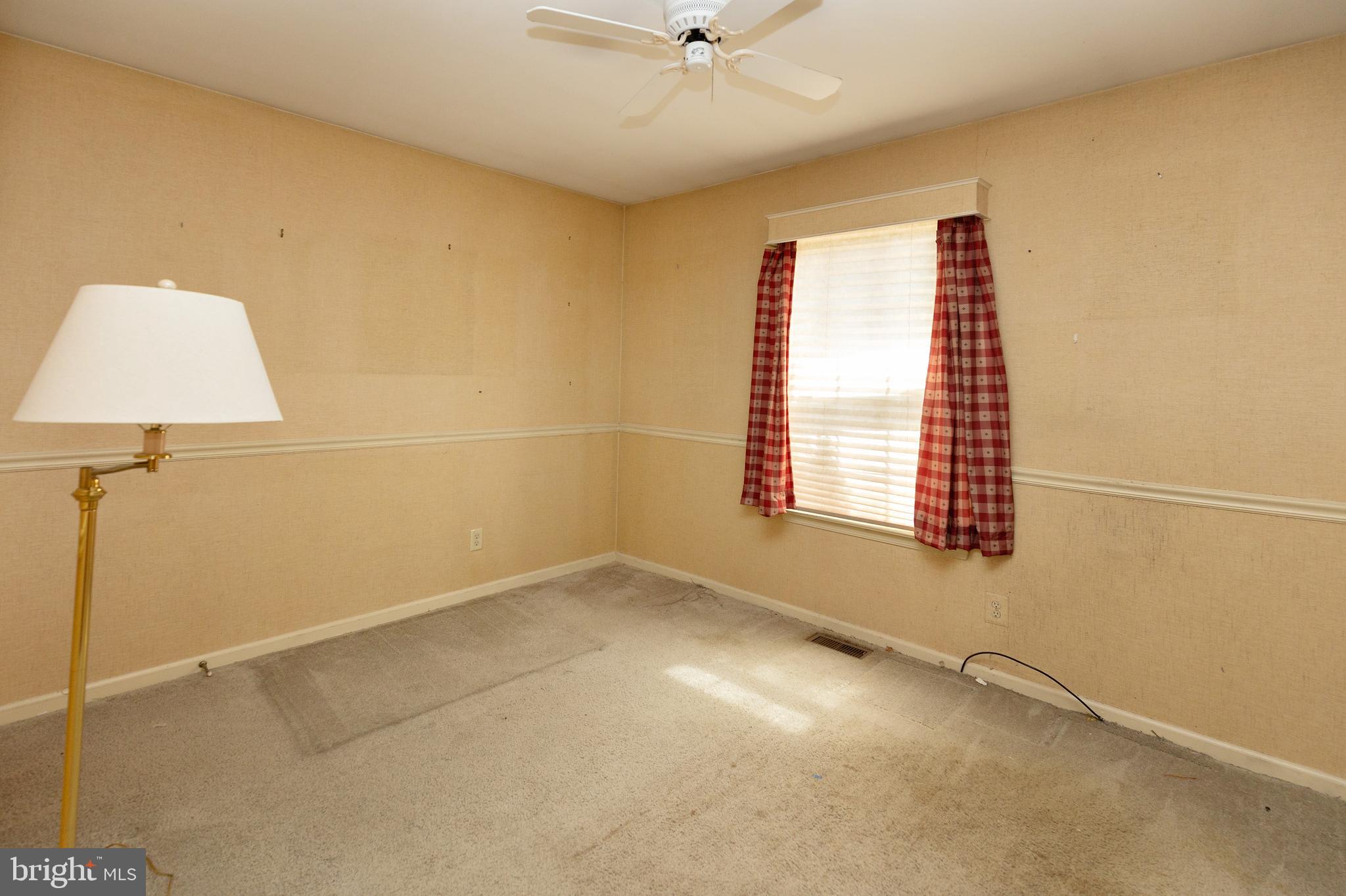 322 West Washington Avenue Magnolia, NJ 08049 - Photo 21 of 28 an empty room with a window and a ceiling fan