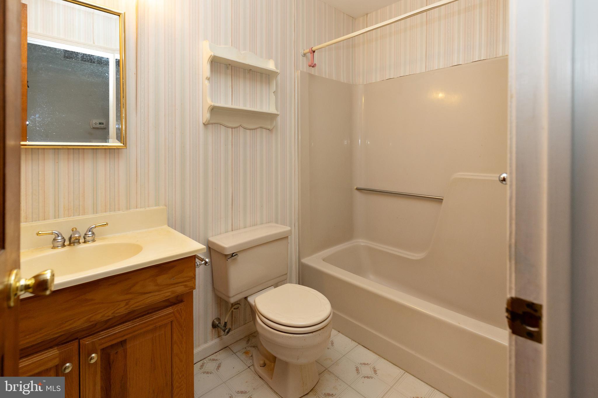 322 West Washington Avenue Magnolia, NJ 08049 - Photo 23 of 28 a bathroom with a sink a toilet and shower