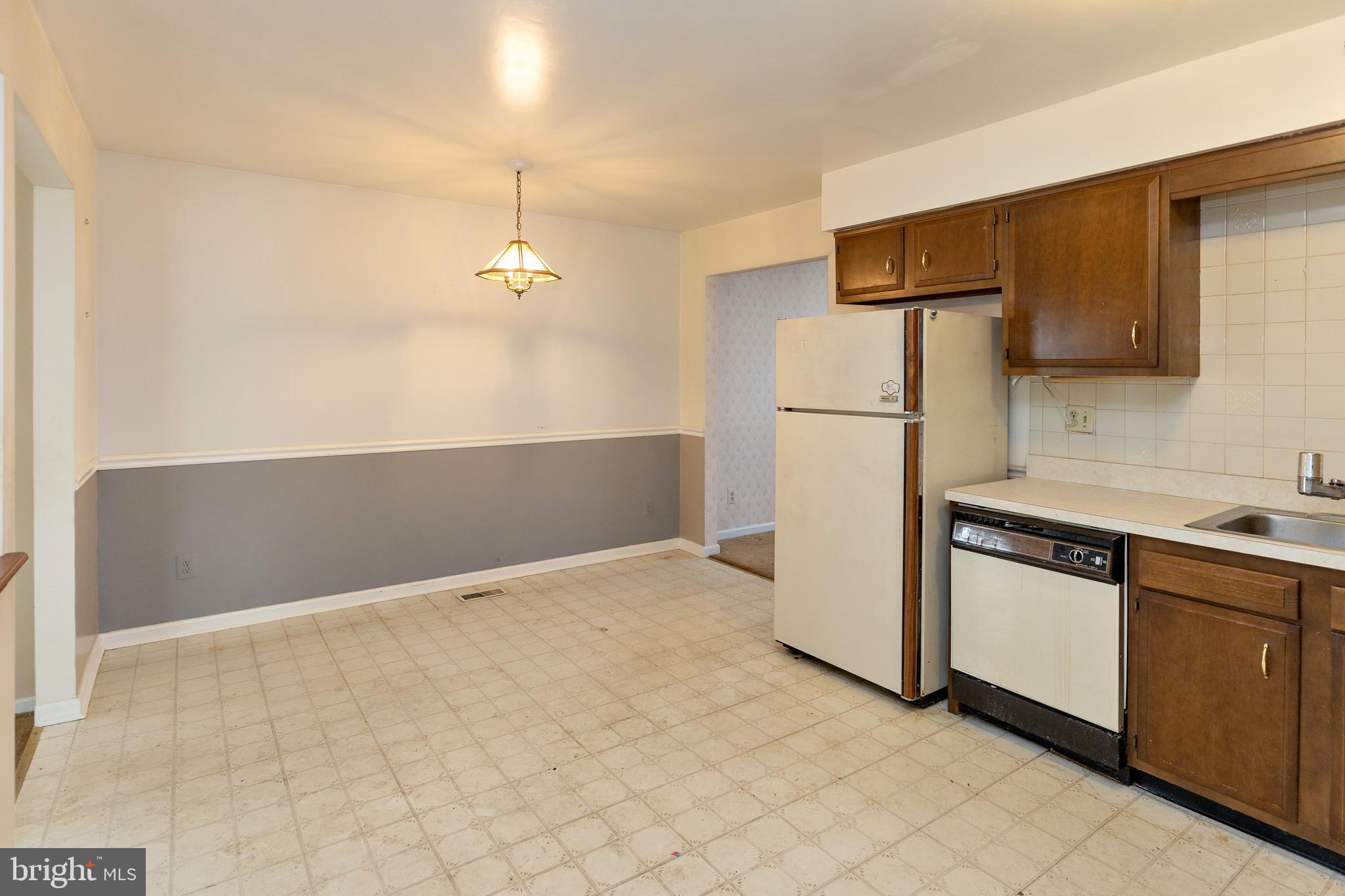 322 West Washington Avenue Magnolia, NJ 08049 - Photo 7 of 28 a kitchen with a refrigerator sink and cabinets