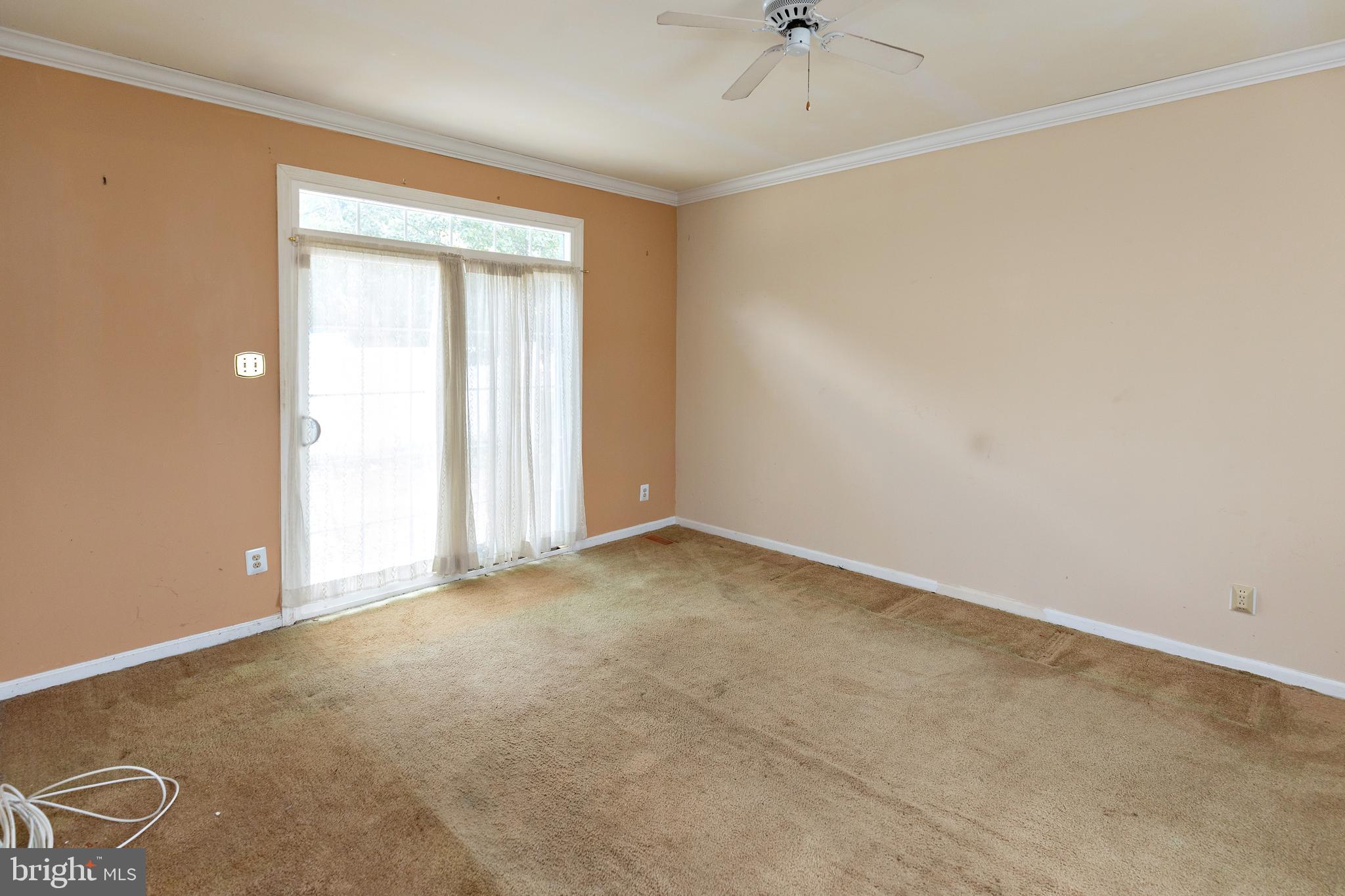 322 West Washington Avenue Magnolia, NJ 08049 - Photo 10 of 28 an empty room with a window and a ceiling fan
