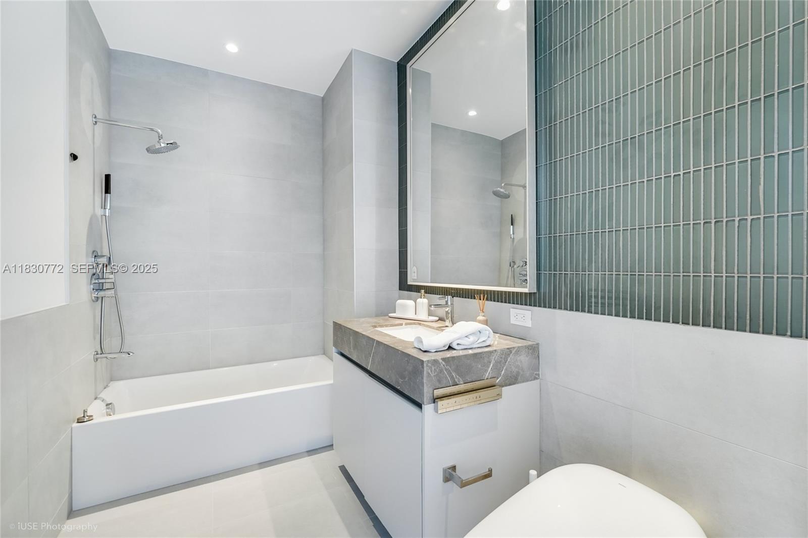 500 Alton Road, Unit 4401 Miami Beach, FL 33139 - Photo 19 of 34 a bathroom with a sink toilet vanity and shower