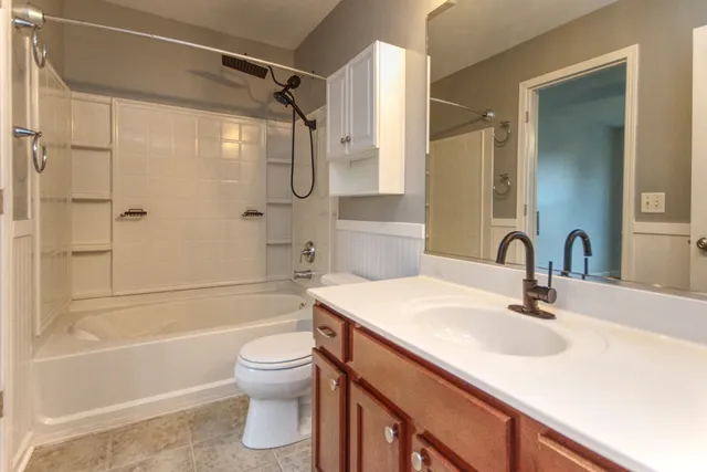 a bathroom with a sink toilet tub and shower
