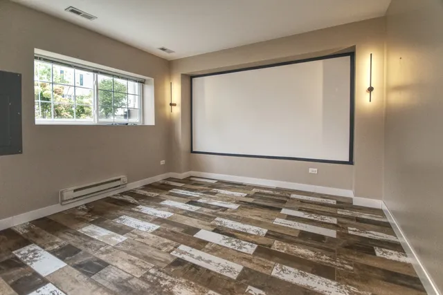 a view of a room with wooden floor and windows