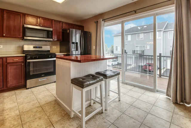 a kitchen with stainless steel appliances a stove a sink and a microwave