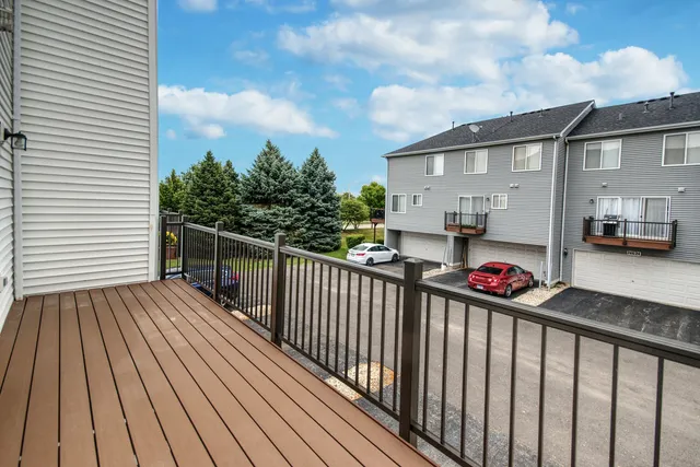 a view of a deck with wooden floor and fence