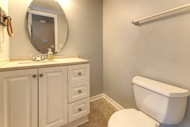 a bathroom with a toilet a sink and mirror