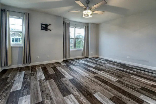 a view of a room with wooden floor