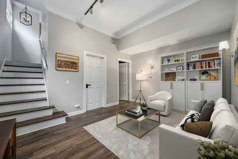 a living room with furniture and wooden floor