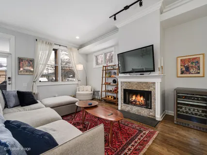 a living room with furniture a flat screen tv and a fireplace