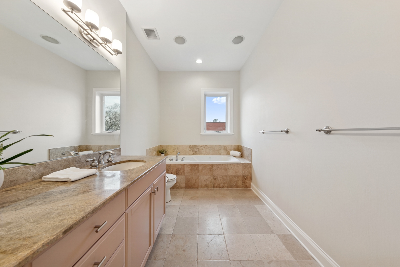 802 West Wolfram Street, Unit 3S Chicago, IL 60657 - Photo 11 of 18 a bathroom with a granite countertop sink a mirror and a bathtub