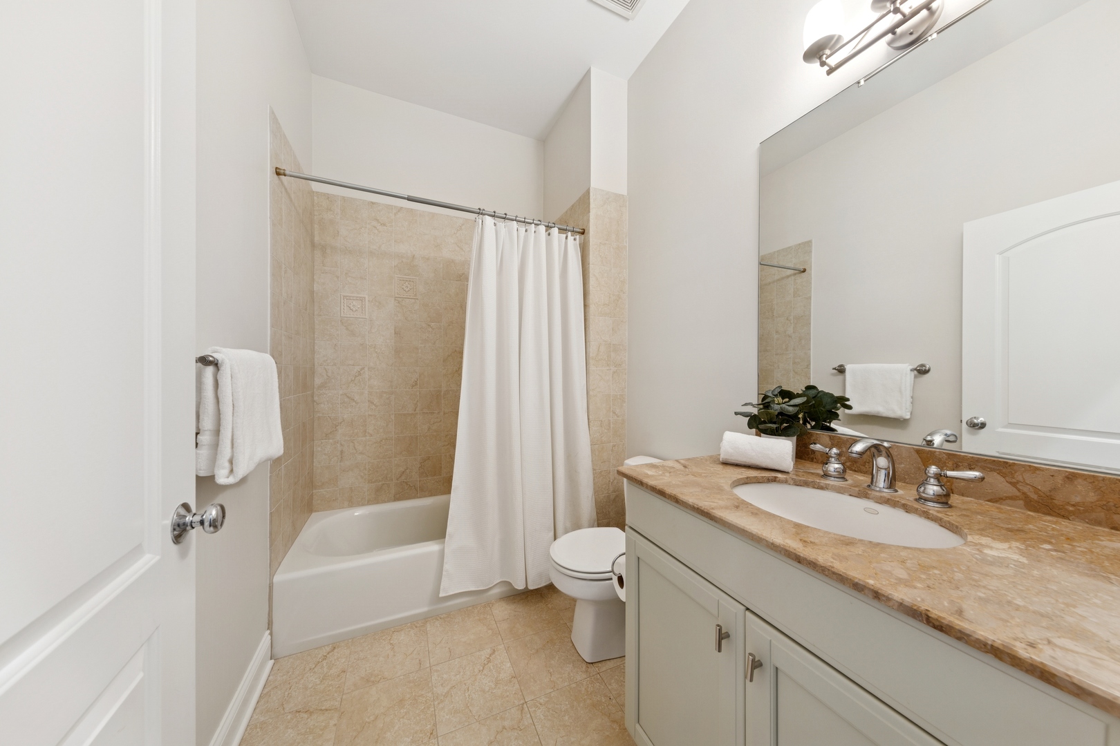 802 West Wolfram Street, Unit 3S Chicago, IL 60657 - Photo 15 of 18 a bathroom with a granite countertop sink a toilet and bathtub