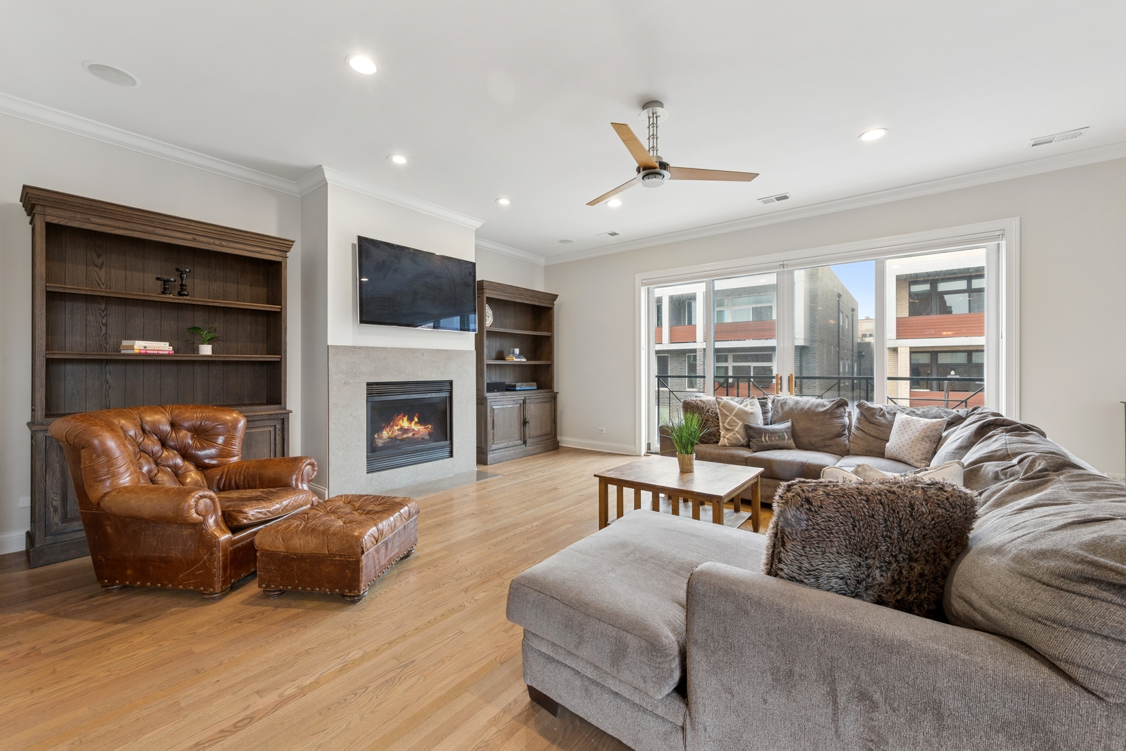 802 West Wolfram Street, Unit 3S Chicago, IL 60657 - Photo 3 of 18 a living room with furniture a flat screen tv and a fireplace