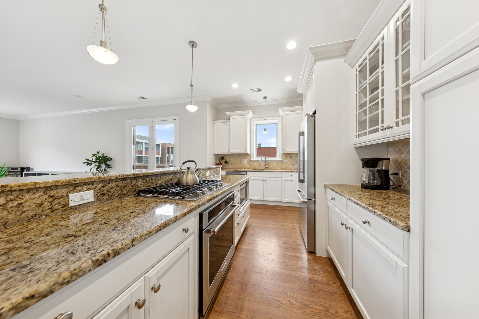 802 West Wolfram Street, Unit 3S Chicago, IL 60657 - Photo 6 of 18 a large kitchen with stainless steel appliances granite countertop a lot of counter space and a sink
