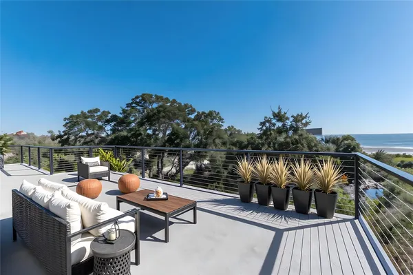 a terrace with outdoor seating and trees