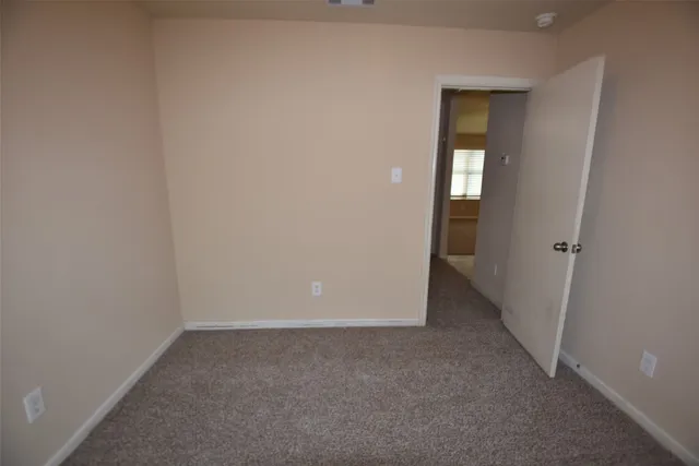 an empty room with closet and mirror
