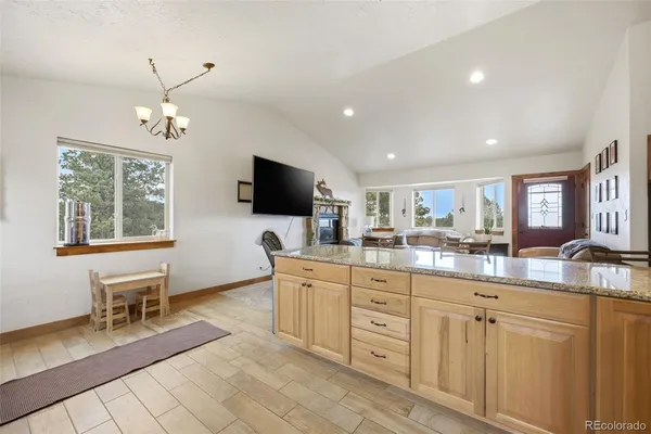 a kitchen with granite countertop a sink and a stove top oven