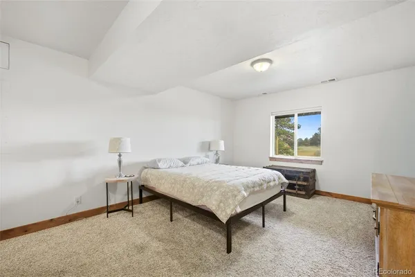 a bedroom with a bed and a table in it