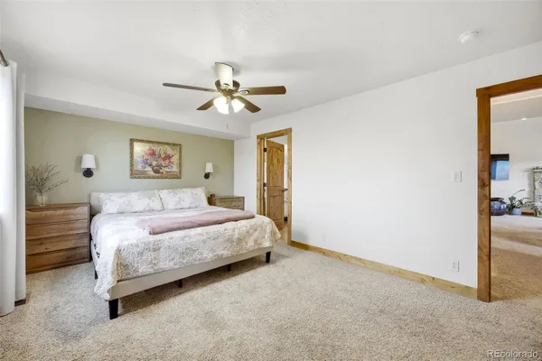 a spacious bedroom with a bed and a chandelier