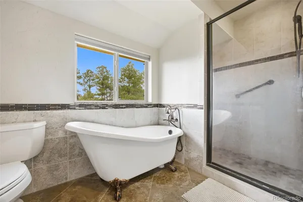 a white bath tub sitting next to a toilet