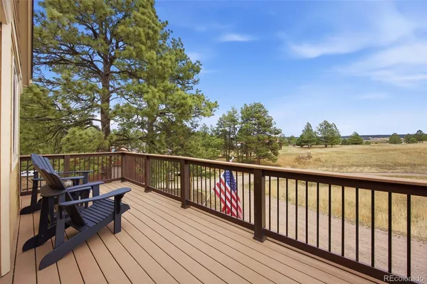 a view of balcony with deck and outdoor seating