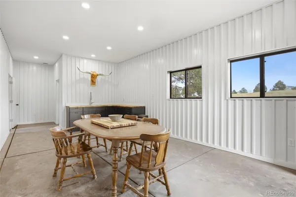 a dining room with furniture and window
