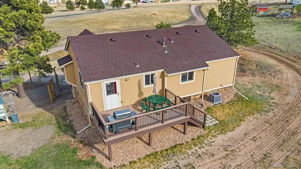 an aerial view of a house with a yard