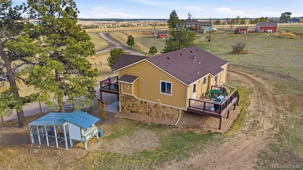 a aerial view of a house with swimming pool and sitting area