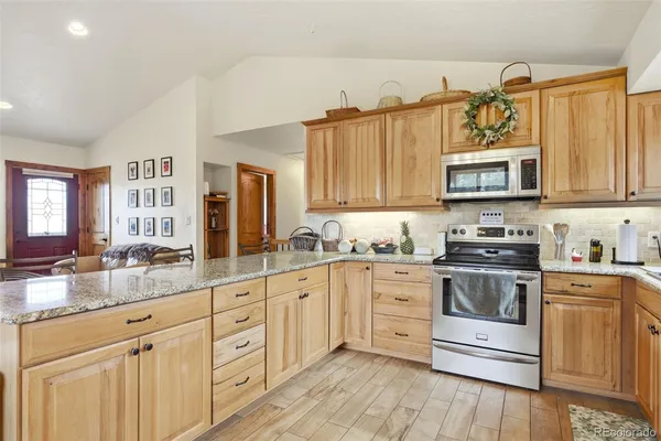 a kitchen with stainless steel appliances granite countertop a stove and a sink