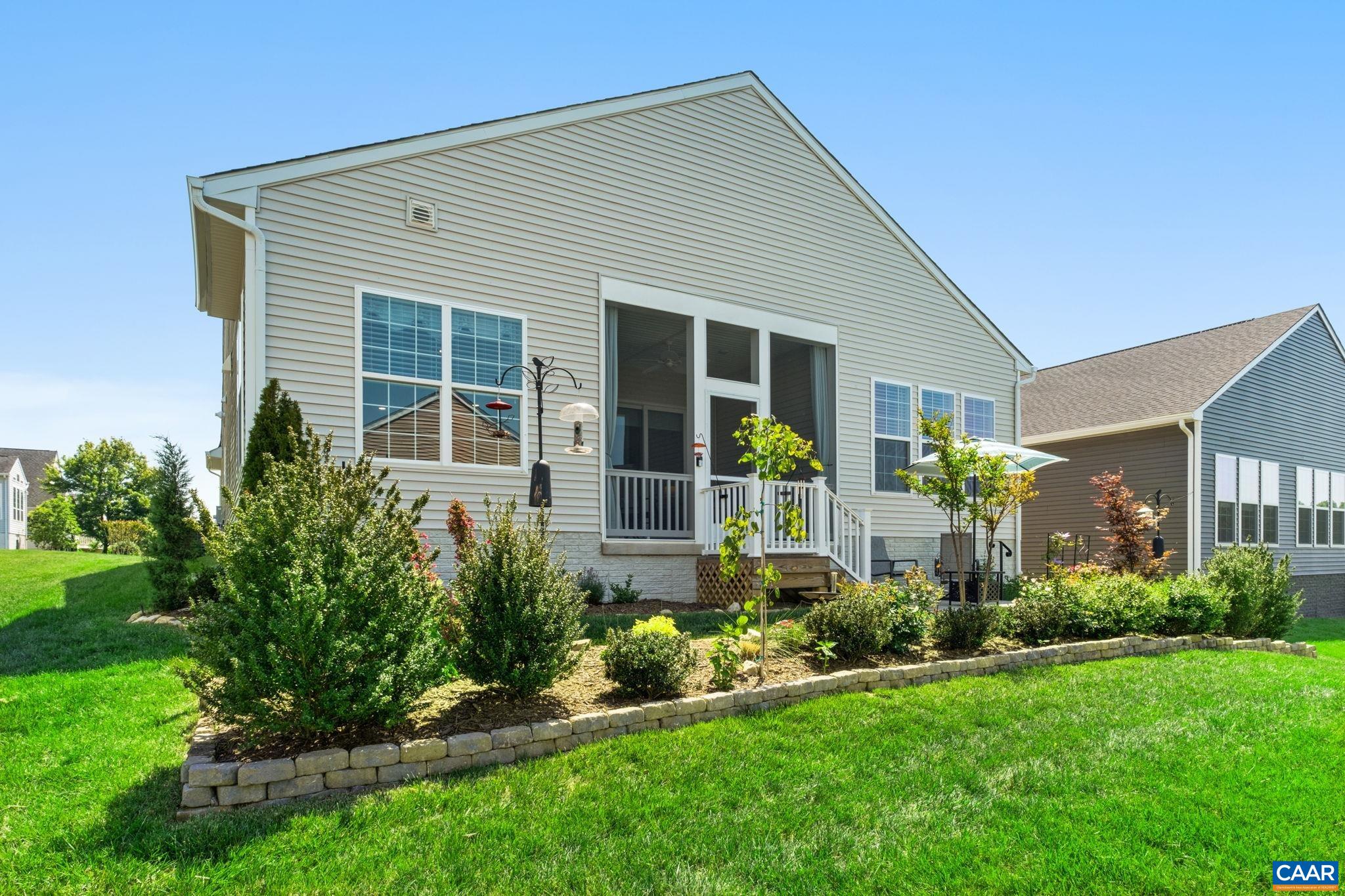 124 Stodghill Drive Ruckersville, VA 22968 - Photo 42 of 58 a front view of a house with a yard and potted plants