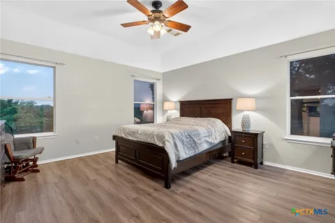 a bedroom with a bed a table and chair