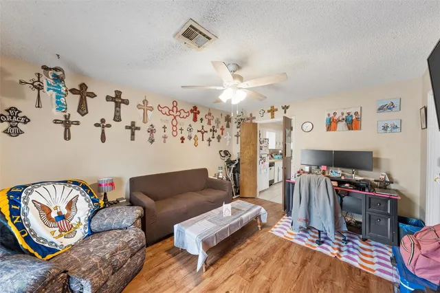 a living room with furniture a flat screen tv and a window