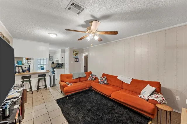a living room with furniture a rug and a chandelier