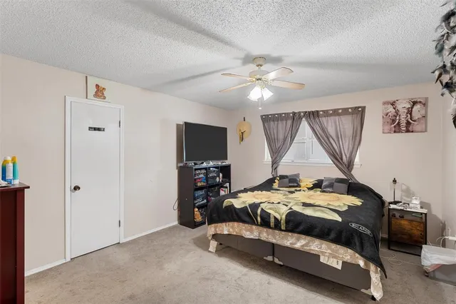 a bedroom with a bed and a tv