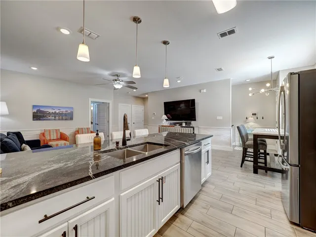 a open kitchen with stainless steel appliances granite countertop a stove and cabinets