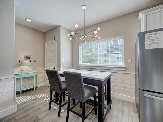 a dining room with a wooden table and chairs