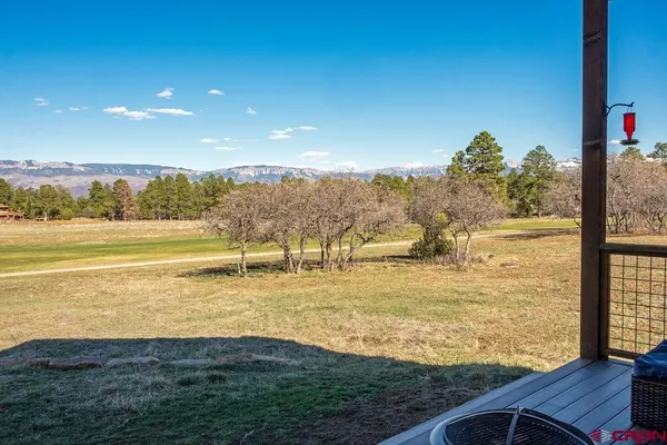 a kitchen with stainless steel appliances granite countertop a refrigerator a stove a sink a stove a dining table and chairs with wooden floor