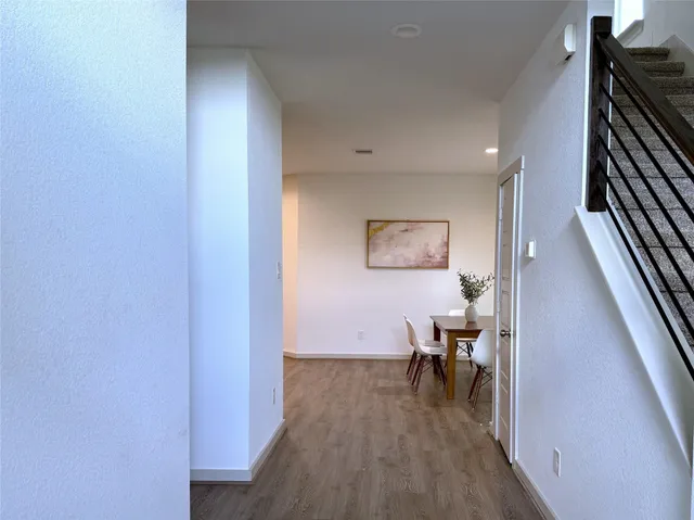 a bedroom with a bed lamp and a potted plant