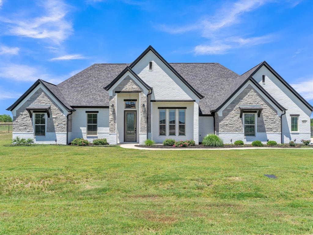 a front view of a house with a yard