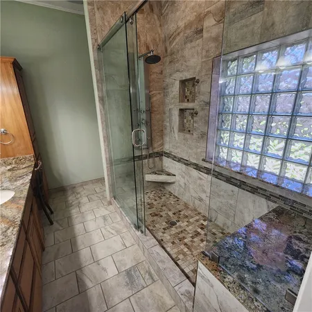 an empty room with a window and a ceiling fan